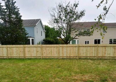 A wood fence on a large property