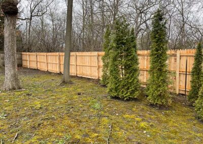 A wood fence on a large property