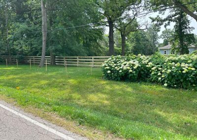 A farm fence along side a road