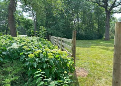 A fence and walkway opening on a large property